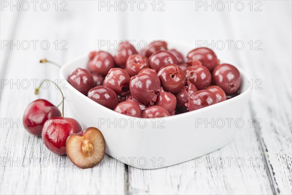 Preserved Cherries on a vintage background as detailed close-up shot, selective focus