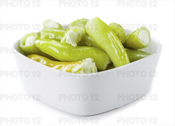 Fresh made Green Chilis (filled with cheese) isolated on white background (close-up shot)