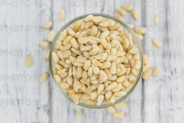 Portion of fresh Pine Nuts (close-up shot, selective focus)
