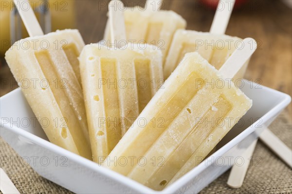 Fresh made Apple Popsicles (selective focus, close-up shot) on a vintage background