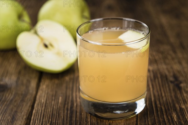 Fresh made Juice (apple) on a vintage background (close-up shot)