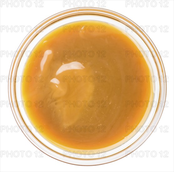 Caramel Sauce on a vintage slate slab (close-up shot, selective focus)