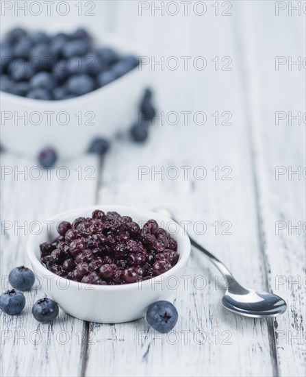Preserved Blueberries on a vintage background as detailed close-up shot, selective focus