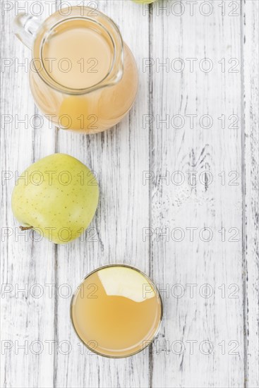 Fresh made Juice (apple) on a vintage background (close-up shot)