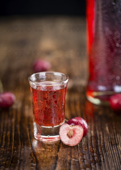 Some homemade Cherry Liqueur as detailed close-up shot, selective focus