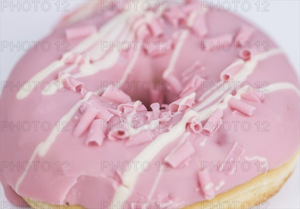 Portion of pink glazed Donuts (detailed close-up shot)