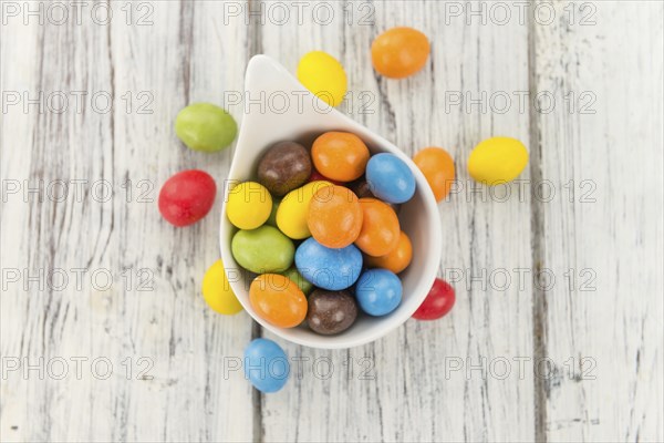 Cocolate coated Peanuts on a vintage background as detailed close-up shot (selective focus)