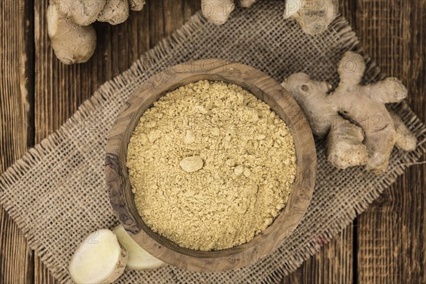 Portion of healthy Ground Ginger on an old wooden table (selective focus, close-up shot)