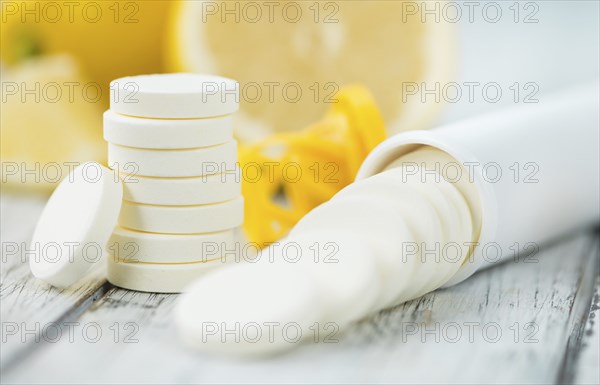 Vitamin C Tablets on a vintage background as detailed close-up shot, selective focus