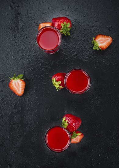 Strawberry liqueur on a vintage slate slab as detailed close-up shot, selective focus