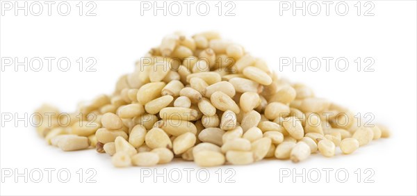 Portion of Pine Nuts (as close-up shot) isolated on white background
