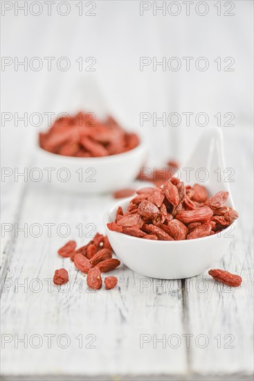 Fresh made Dried Goji Berries on a vintage background (close-up shot)