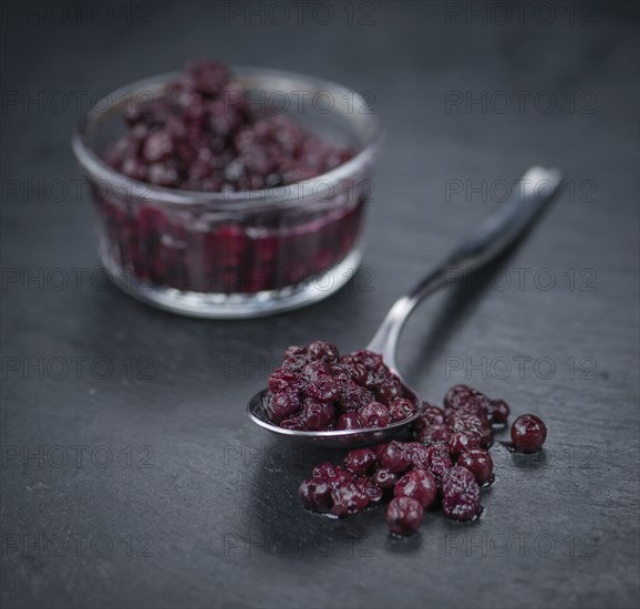 Preserved Blueberries on a vintage background as detailed close-up shot, selective focus