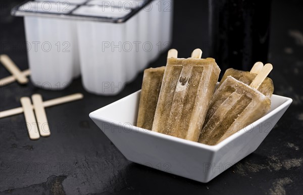 Cola Popsicles (selective focus) on a vintage background as detailed close-up shot