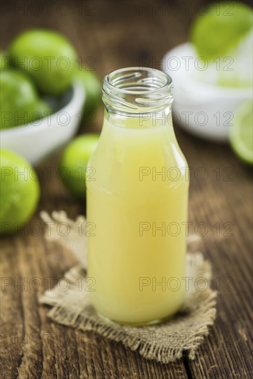Lime Juice on a vintage background as detailed close-up shot (selective focus)