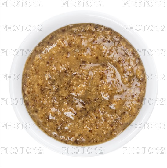 Portion of Sweet Mustard (as close-up shot) isolated on white background