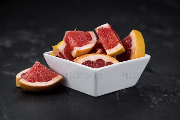 Grapefruits slices (selective focus) on a vintage background as detailed close-up shot