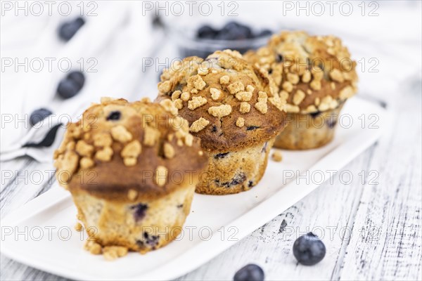 Fresh Blueberry Muffins as detailed close-up shot (selective focus)