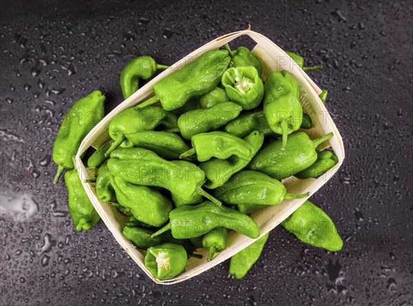 Portion of Raw Pimientos on a rustic slate slab, selective focus, close-up shot