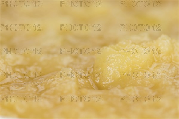 Portion of homemade Applesauce (selective focus, close-up shot) on vintage background