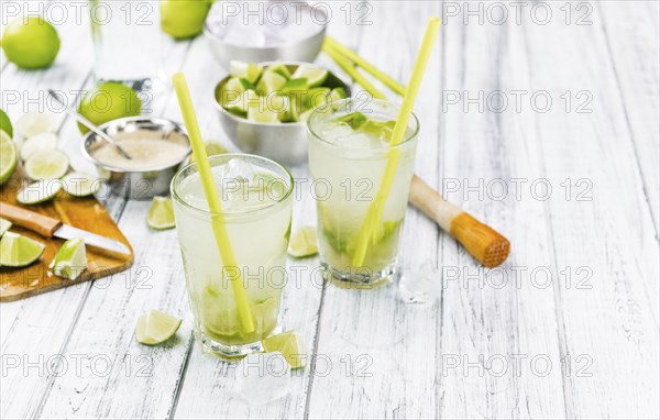 Fresh made Caipirinha with ingredients in the background