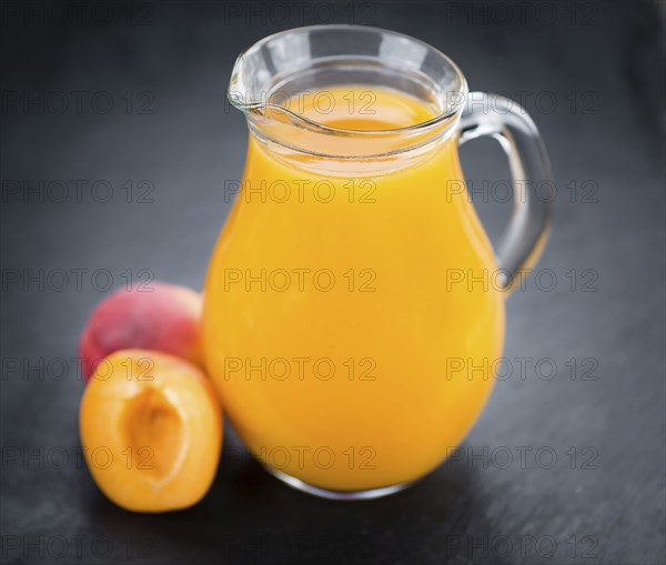Apricot Juice on a vintage slate slab (close-up shot, selective focus)