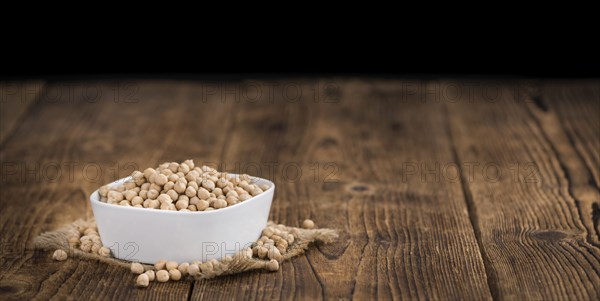 Chickpeas on a vintage background as detailed close-up shot, selective focus