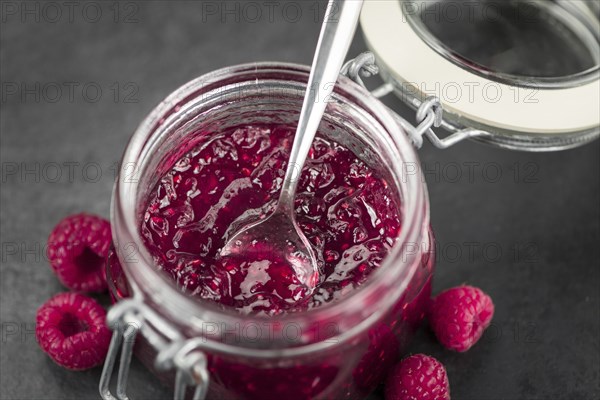 Fresh made Raspberry Jam on a vintage background as detailed close-up shot