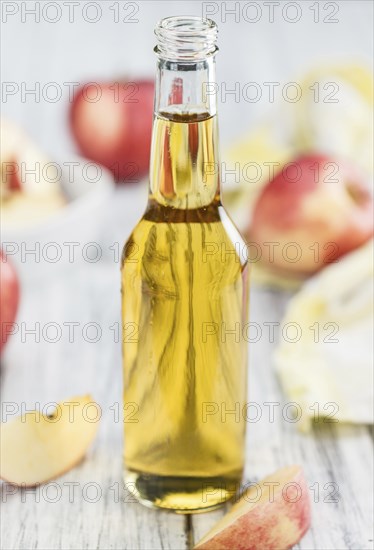 Fresh made Apple Cider on a vintage background (close-up shot)