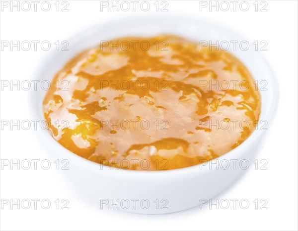 Portion of fresh made Apricot Jam isolated on white background