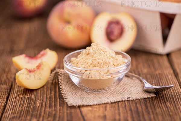 Peach powder on an old wooden table as detailed close-up shot, selective focus