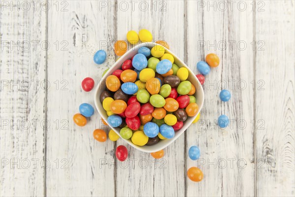Fresh made Cocolate coated Peanuts on a vintage background (close-up shot)