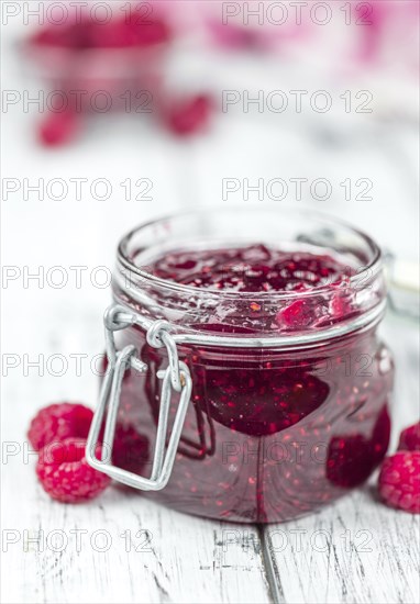 Fresh made Raspberry Jam on a vintage background as detailed close-up shot