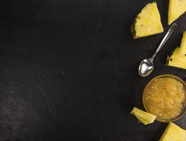 Portion of Pineapple Jam on a rustic slate slab, selective focus, close-up shot