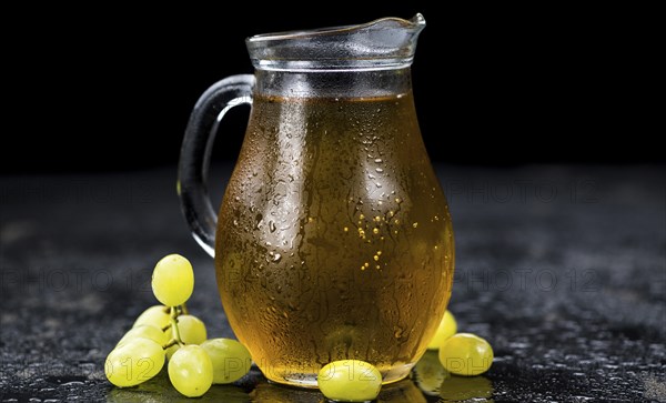 Some healthy Grape Juice on a vintage slate slab (selective focus)