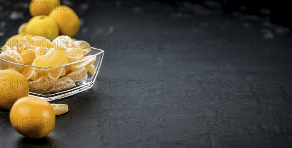 Raw Tangerine pieces (close-up shot) on vintage background