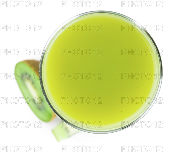 Fresh made Kiwi Smoothie isolated on white background (close-up shot, selective focus)