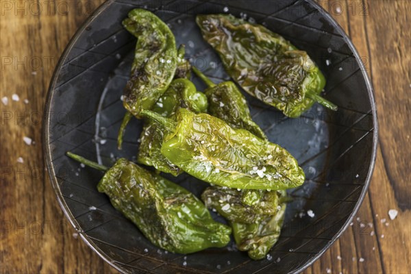 Portion of fresh Pimientos de Padron close-up shot, selective focus