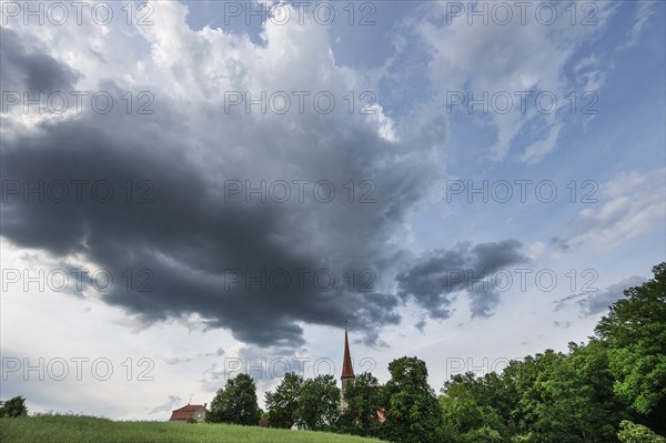 Rain clouds (Nimbostratus), over the church in Beerbach, Middle Franconia, Bavaria, Germany,