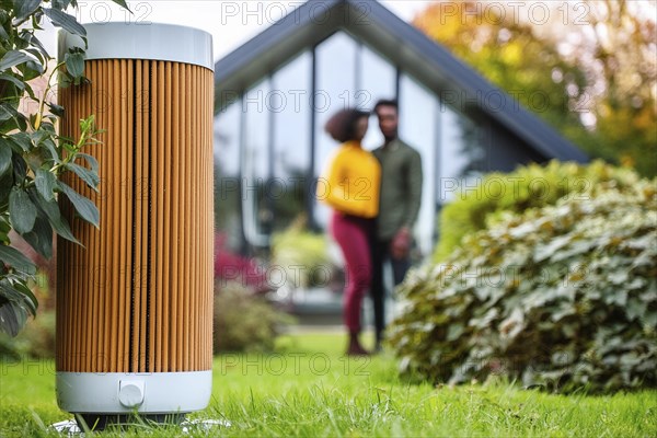 Modern air purifier in a garden, blurred view of a couple in the background, AI generated, AI