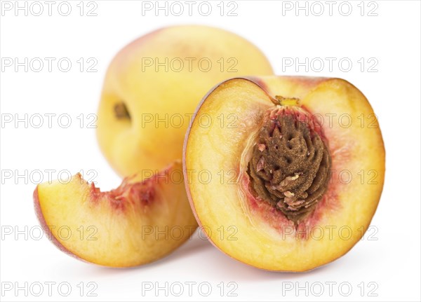 Portion of Peaches as detailed close-up shot isolated on white background