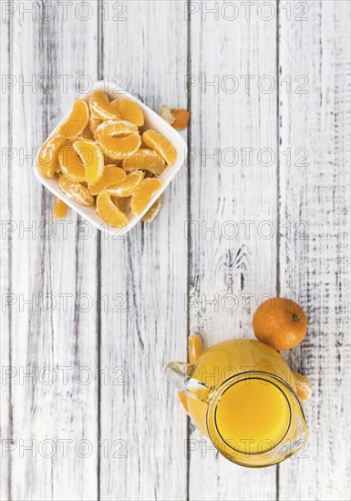 Portion of fresh made Tangerine Juice (close-up shot, selective focus)