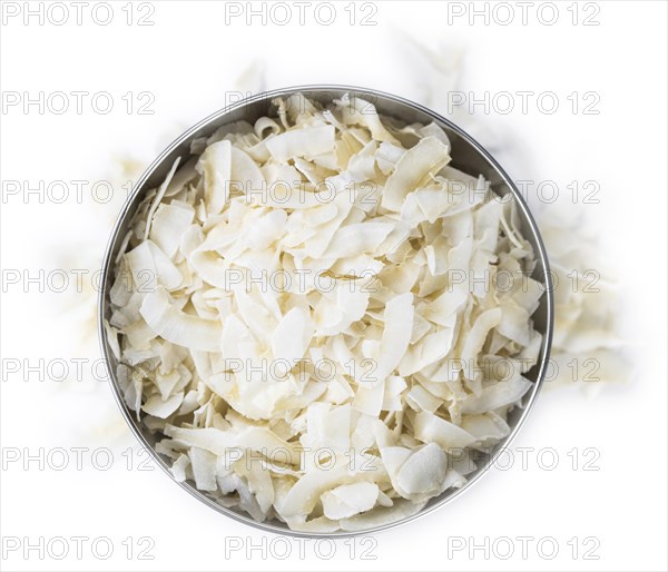 Portion of Coconut Chips isolated on white background (selective focus)
