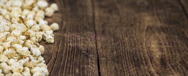 Fresh made Popcorn on a vintage background as detailed close-up shot