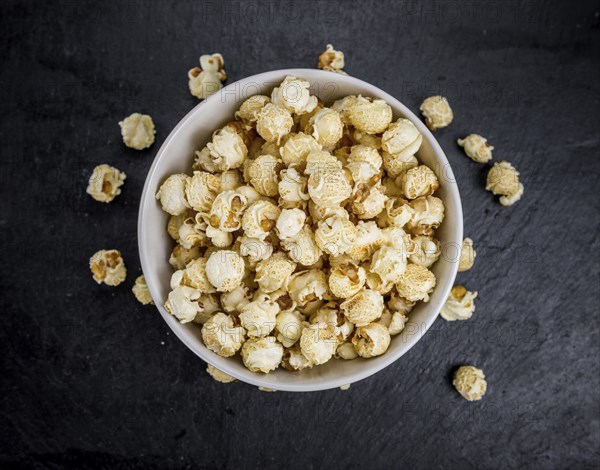 Some Popcorn on a slate slab as detailed close-up shot, selective focus
