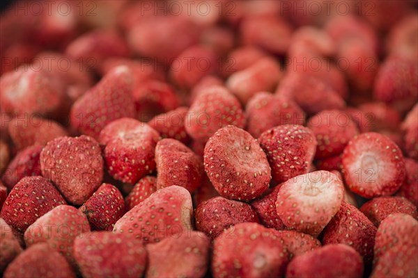 Dried Strawberries on rustic wooden background as close-up shot