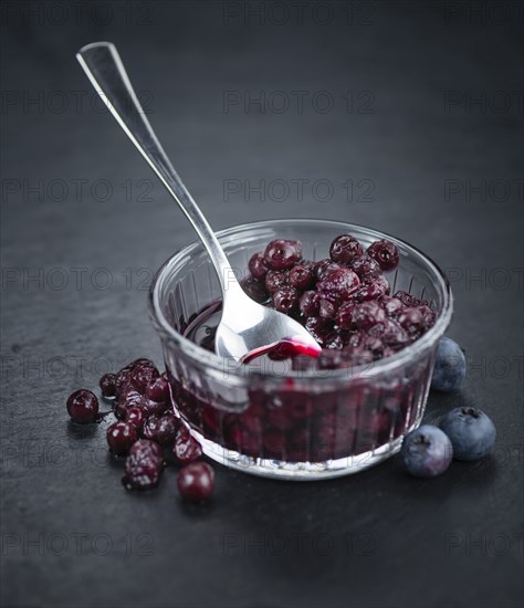 Some fresh Preserved Blueberries on a vintage slate slab, selective focus, close-up shot