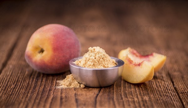Peach powder on an old wooden table as detailed close-up shot, selective focus