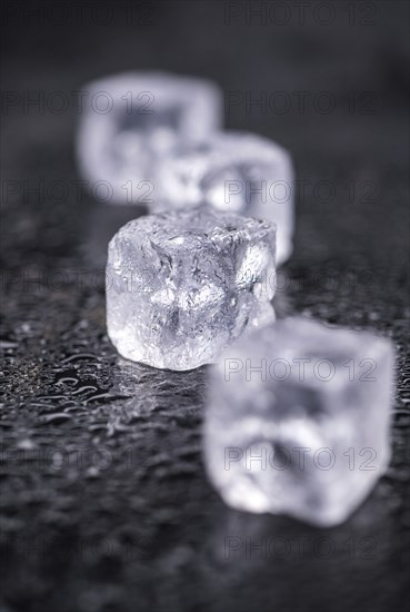 Some melting Ice cubes on a vintage slate slab (selective focus)