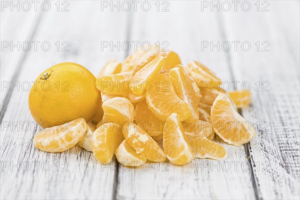 Raw Tangerine pieces (close-up shot) on vintage background
